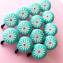 A group of pretty bike bells with Flannel Flower designs on the mint coloured bike bells