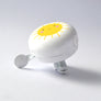WHITE BIKE BELL WITH YELLOW SUNSHINE FACE ON TOP