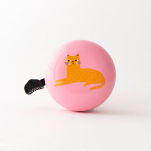 A pink bicycle bell with a printed orange cat design on it, featuring a black push lever.