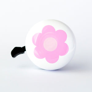 A white bike bell with a pretty dusty pink retro flower design.