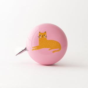 A pink bicycle bell with a lazy cat design in orange on the top.  Cute bike bell