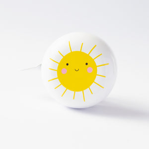 WHITE BIKE BELL WITH YELLOW HAPPY SUNSHINE FACE ON TOP