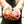 A Super hero orange bike bell and a multi-coloured dotted bike bell held in womens hands